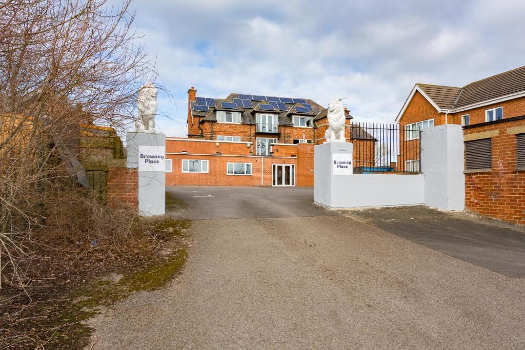 a house with a gate in front of a driveway at Browney Place in Durham