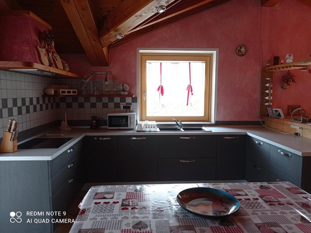 a kitchen with a sink and a window at Torrent du Chateau casa vacanze in Aosta