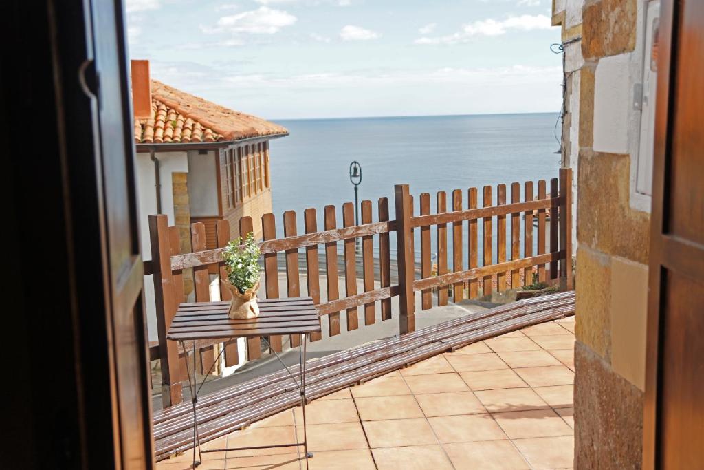 a balcony with a table and a view of the ocean at LOFT NORDESTE in Lastres