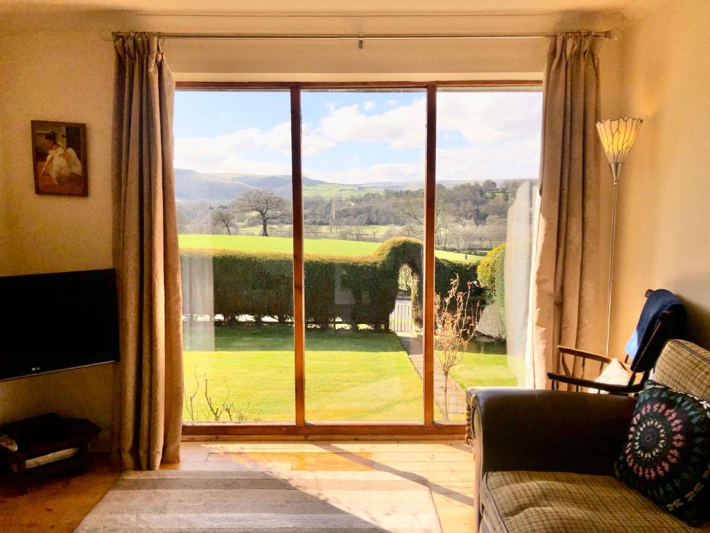 a living room with a large window with a view at Derwent View in Bamford