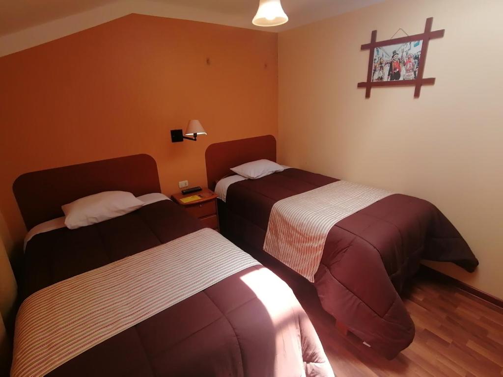 Postel nebo postele na pokoji v ubytování Conquista Cusco
