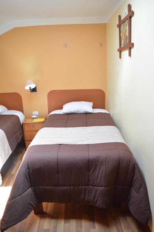 Postel nebo postele na pokoji v ubytování Conquista Cusco
