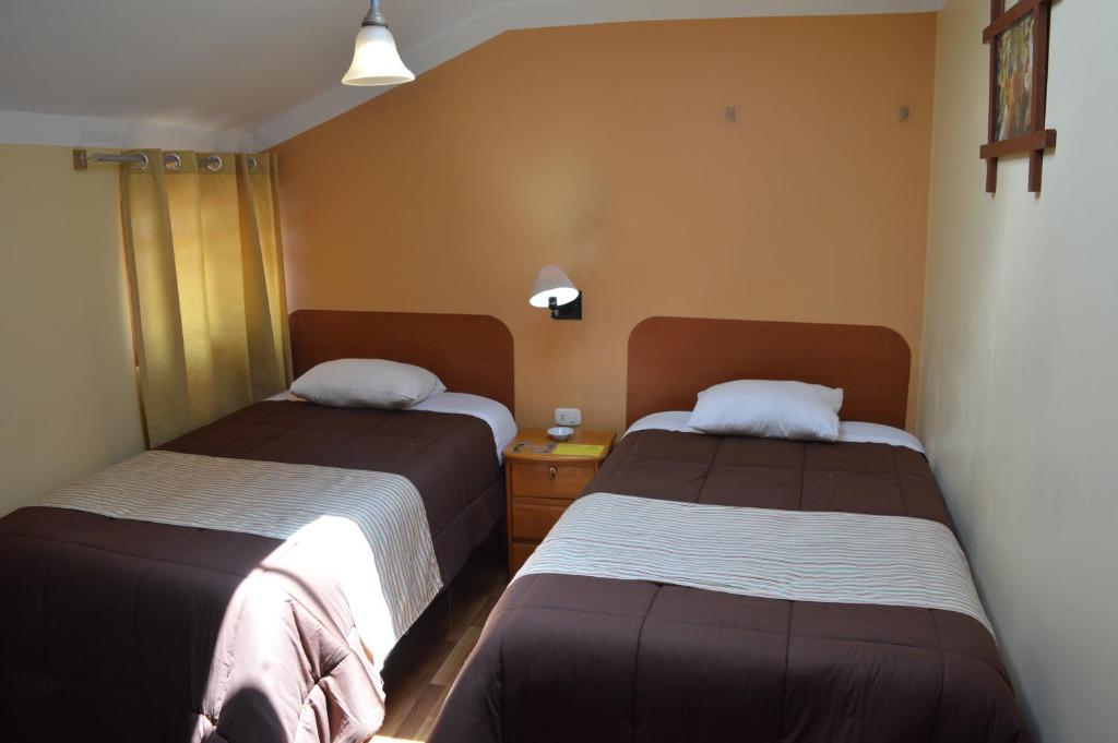 Postel nebo postele na pokoji v ubytování Conquista Cusco