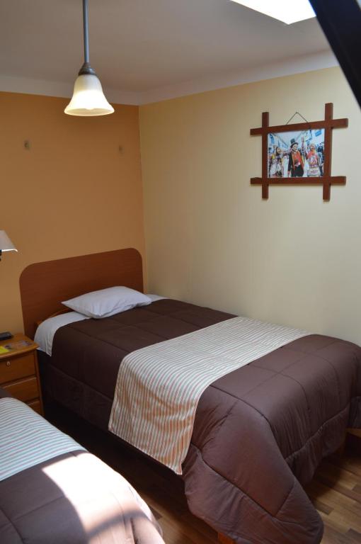Postel nebo postele na pokoji v ubytování Conquista Cusco