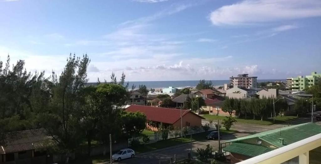 a view of a town with the ocean in the background at Residencial Lazzari Apto 402 in Arroio do Sal