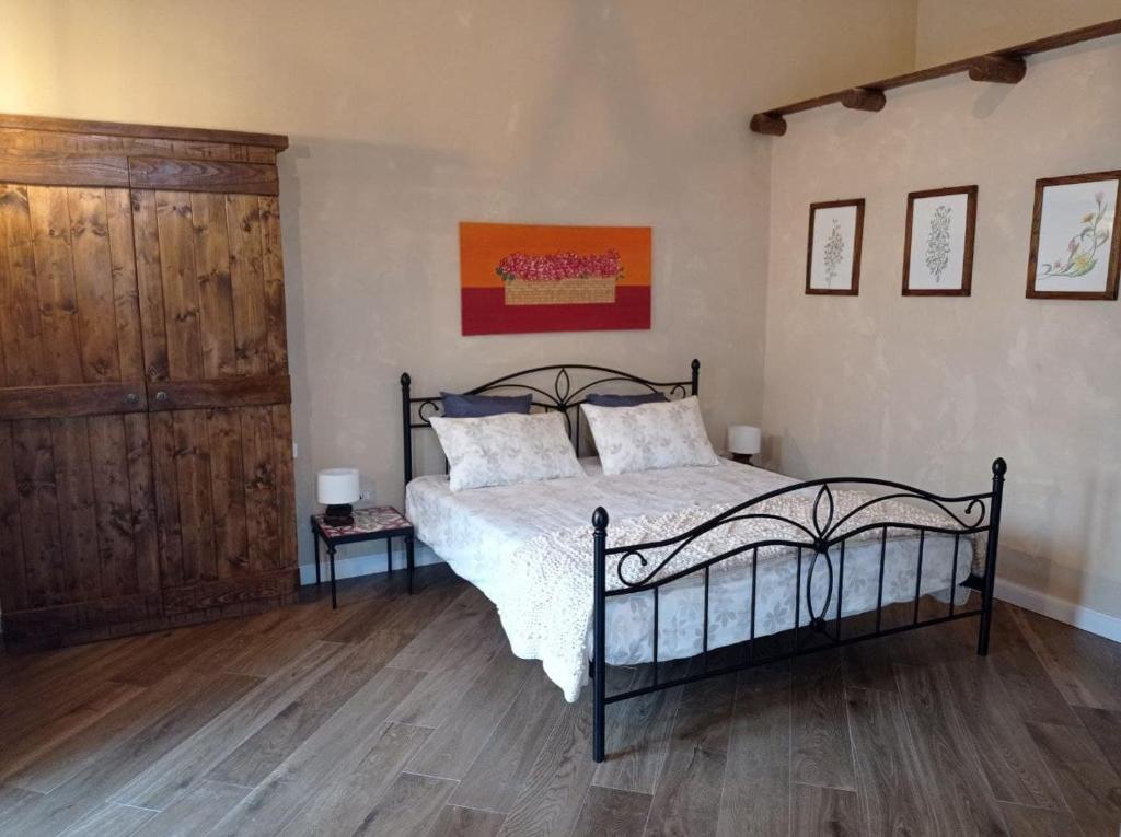 a bedroom with a bed and a wooden floor at Villa Mazza al Vesuvio in Torre del Greco
