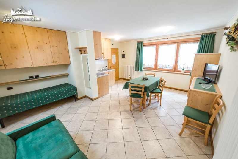 una sala de estar con un sofá y una mesa en Baita Epi Cusini by Livigno Accomodation, en Livigno