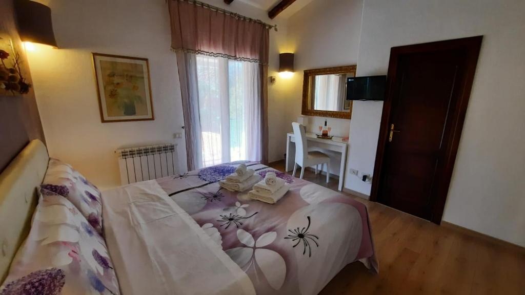 a bedroom with a bed and a table and a desk at Villa Kuky in Santa Teresa Gallura