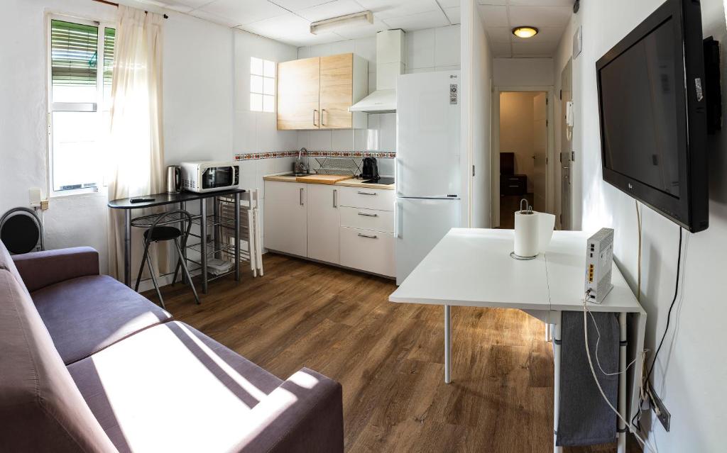 a living room with a couch and a white table at Apartment Triana 2 in Seville