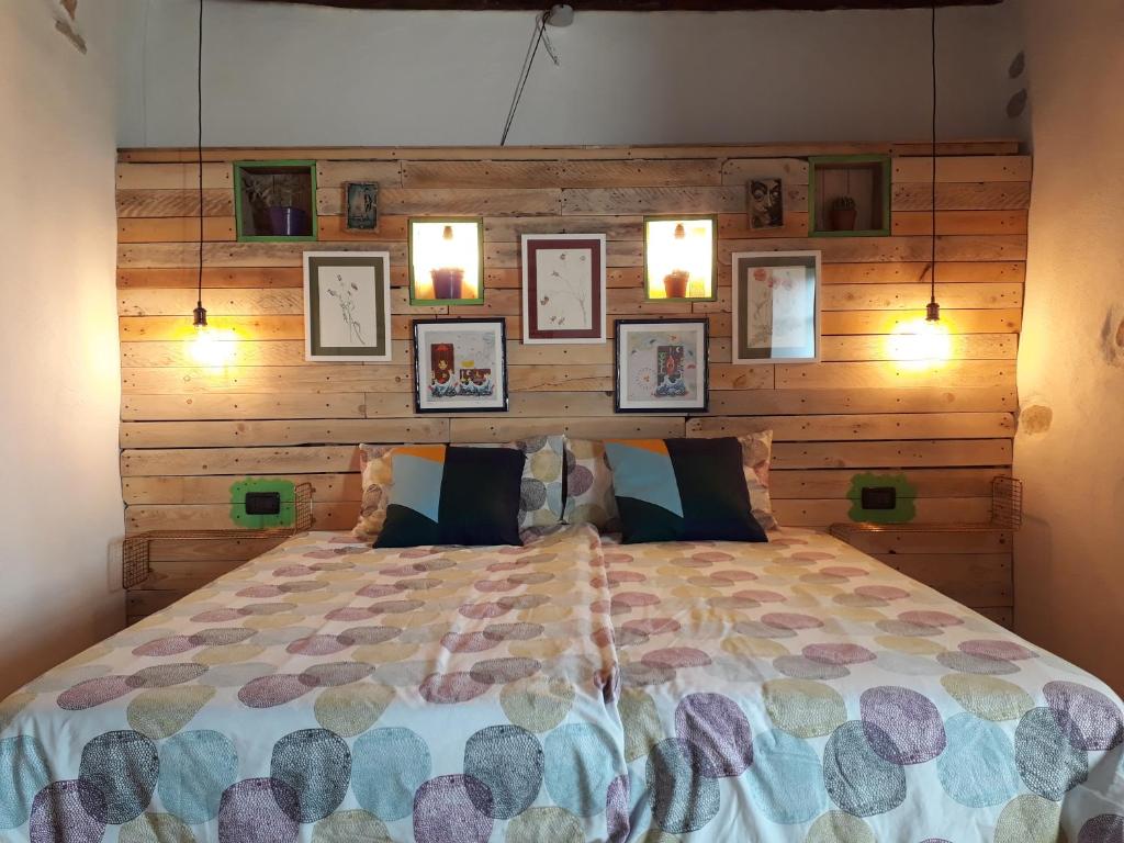 a bedroom with a large bed with a wooden wall at Affittacamere Le Ciboline in Beverino