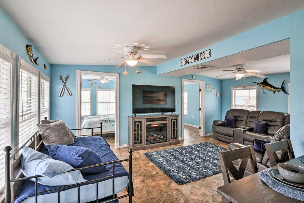 a living room with blue walls and a fireplace at Surfside Beach Gem with Deck - 1 Block to Shore! in Freeport