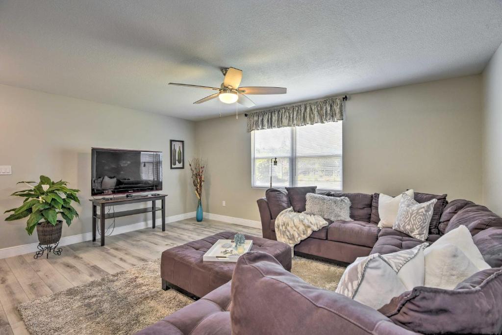 a living room with a couch and a tv at Coastal Sarasota Condo Minutes to Beach! in Sarasota