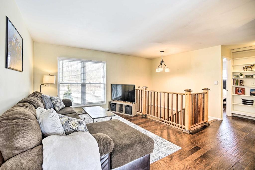 a living room with a couch and a tv at Updated Home in the Heart of Saratoga Springs in Saratoga Springs