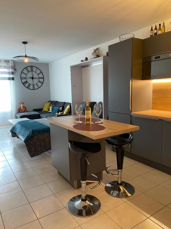 a kitchen with a table with wine glasses on it at Studio Disneyland Paris Holidays in Montévrain