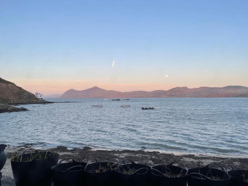 a large body of water with boats in it at Bryn Noddfa in Morfa Nefyn