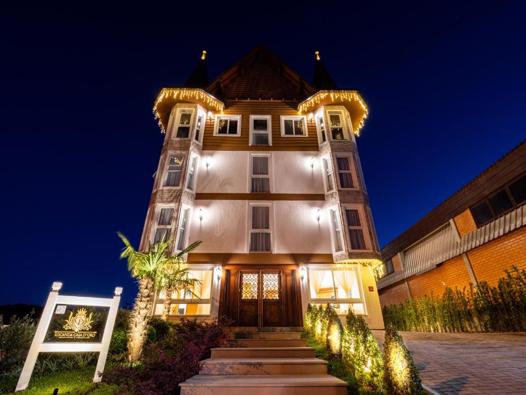a large building with lights on it at night at Hotel Locanda Casa D'Oro in Gramado