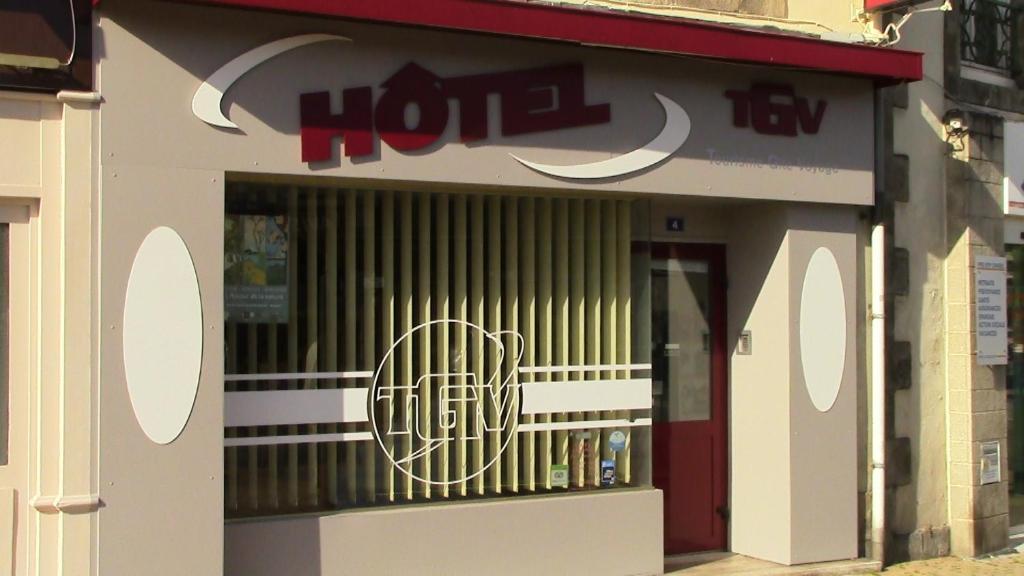 a store front with a window with a sign on it at Hotel TGV in Quimper