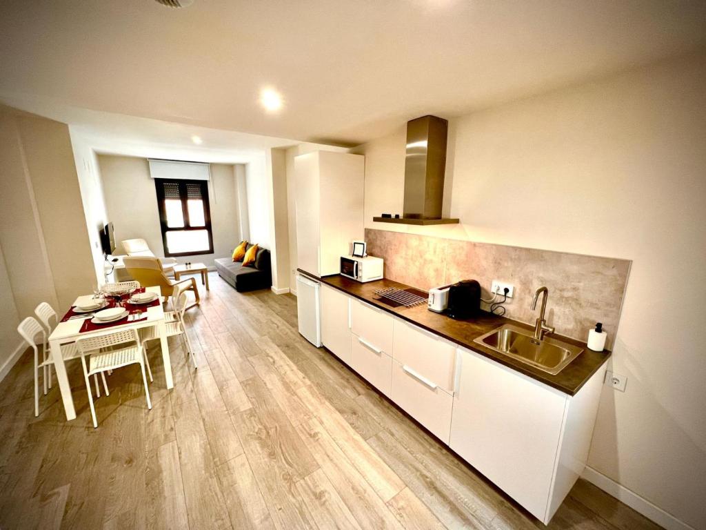 a kitchen with a sink and a table in a room at Apartamento Jazmín in Córdoba