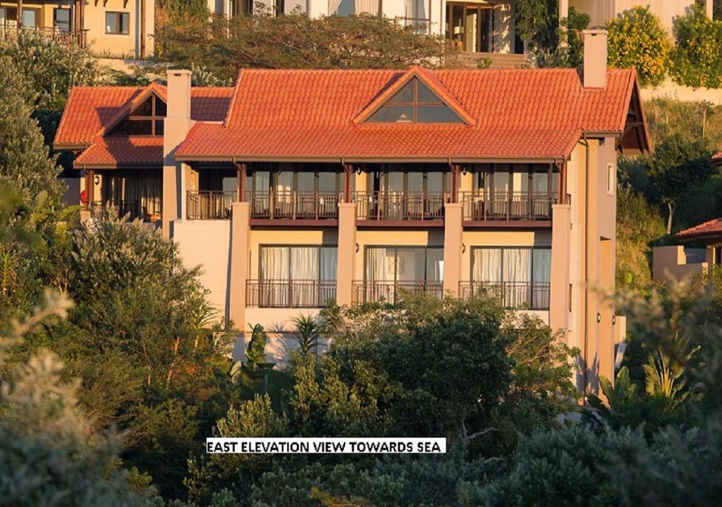 an apartment building with an orange roof at 13 Yellowwood - with back-up power in Ballito