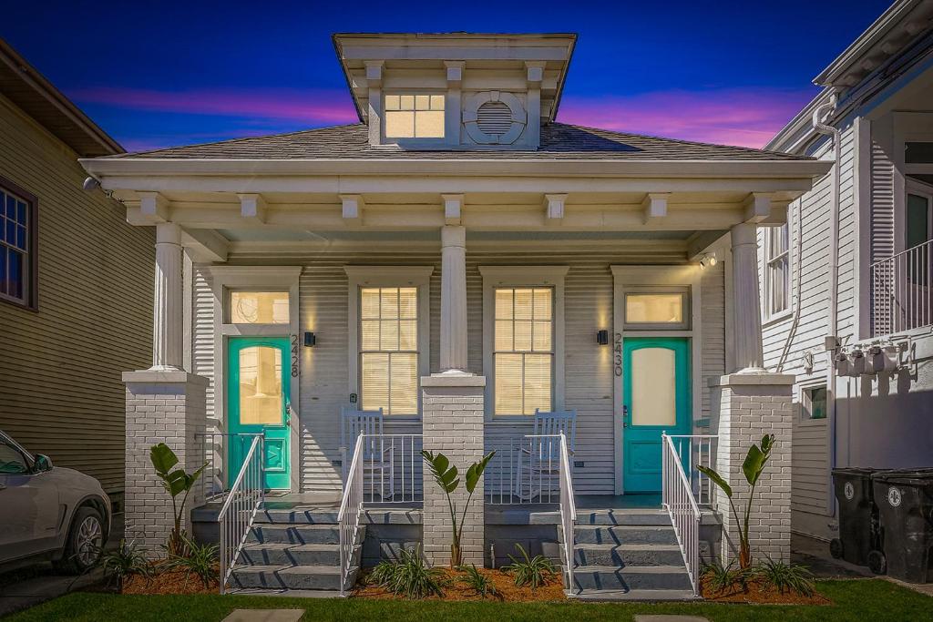 a house with a green door and stairs at Private 2BR in Uptown by Hosteeva in New Orleans