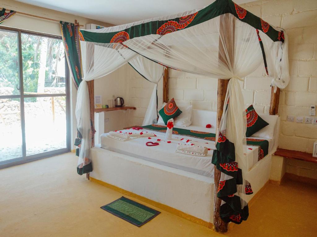Postel nebo postele na pokoji v ubytování Tropicana Garden