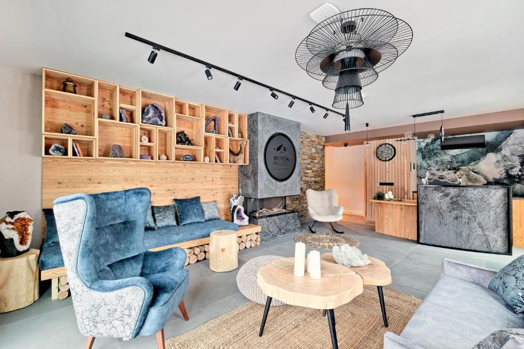 a living room with a blue couch and a table at Harda House Friends & Spa in Zakopane