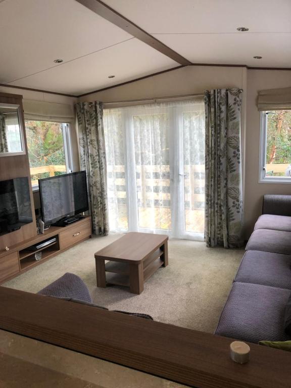 a living room with a couch and a tv at River View in Dunoon