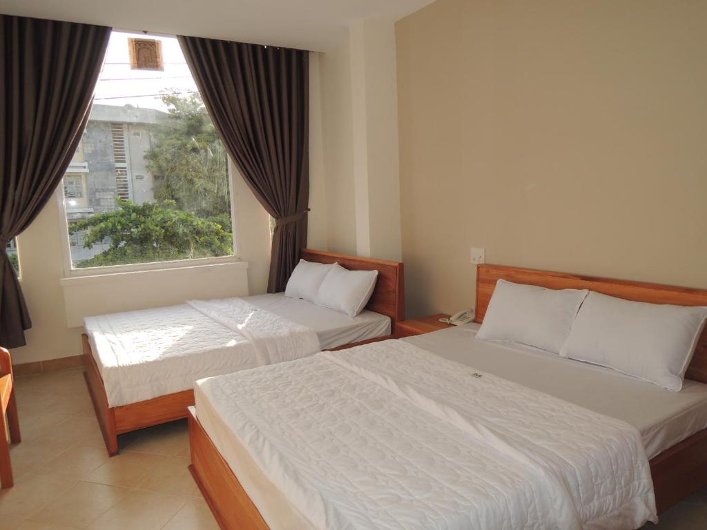 En eller flere senge i et værelse på Đinh Gia Hotel