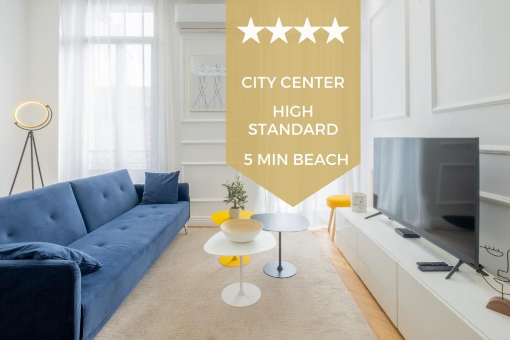 un soggiorno con divano blu e TV di 3-bedroom apartment in the heart of Cannes a Cannes