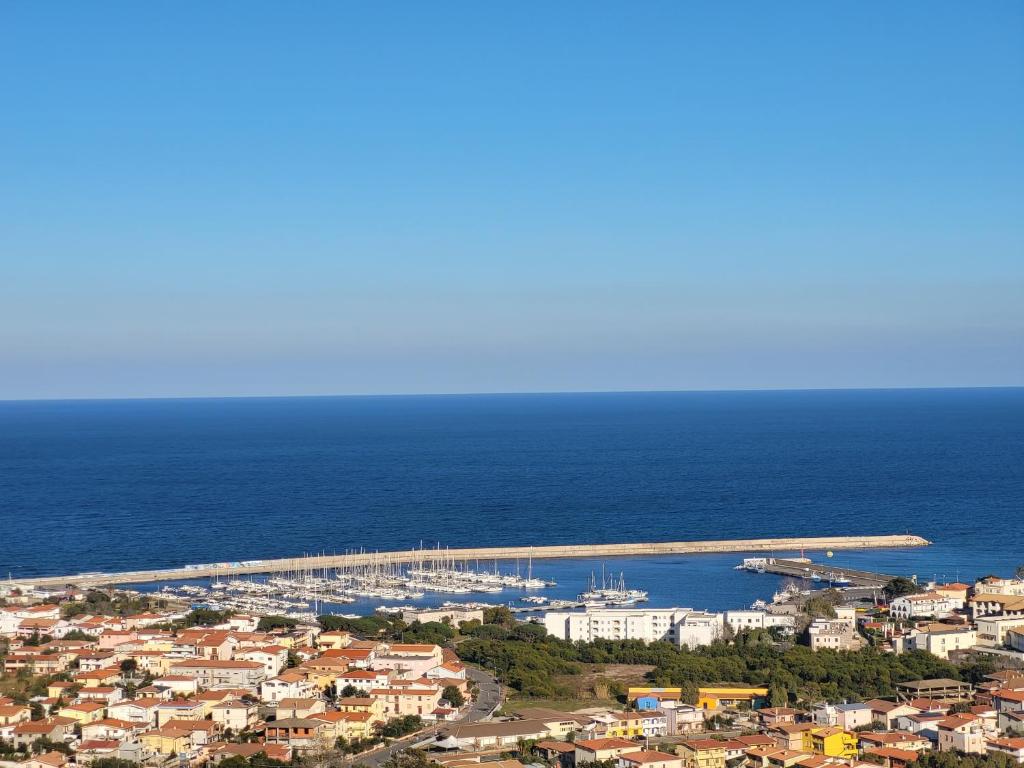 an aerial view of a city and a bridge over the ocean at White Sand affittacamere in La Caletta
