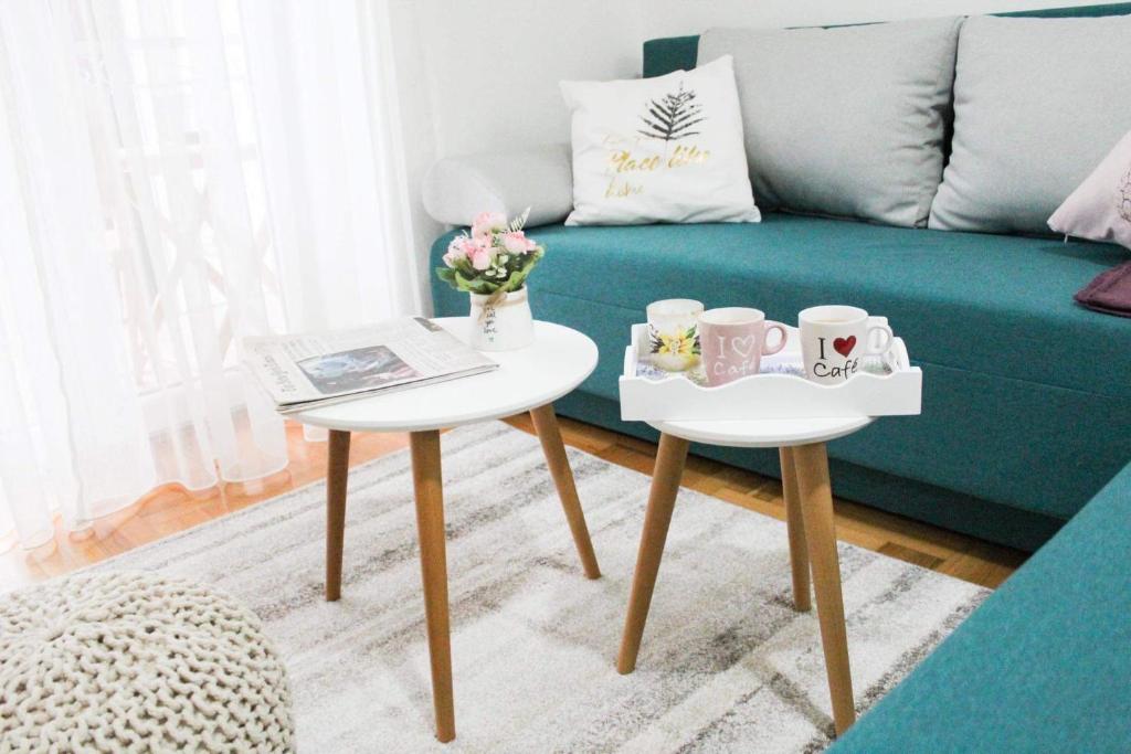 a living room with two tables and a couch at Apartment Atria in Vrnjačka Banja