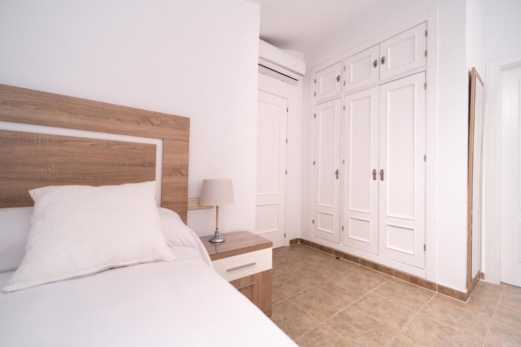 Łóżko lub łóżka w pokoju w obiekcie Duplex 8 Caños