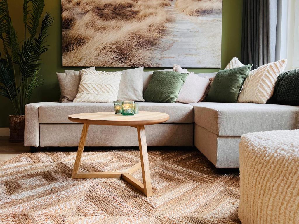 a living room with a couch and a coffee table at Abbey Green Lodge in Breda