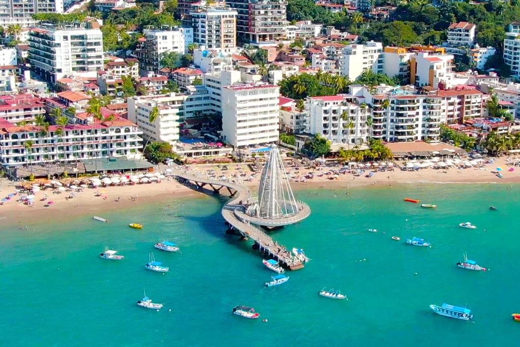 an aerial view of a beach with boats in the water at Hotel Delfin Puerto Vallarta in Puerto Vallarta