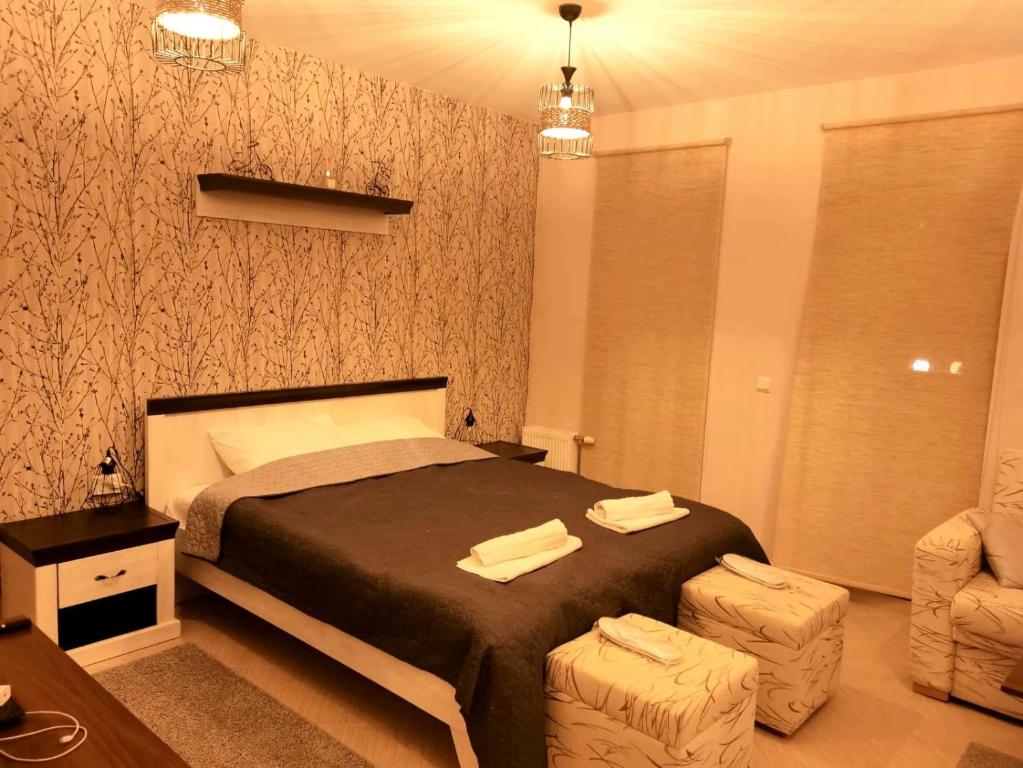 a bedroom with a bed with two towels on it at Mouse&Mutton Studios in Green Life Ski&Spa Bansko in Bansko
