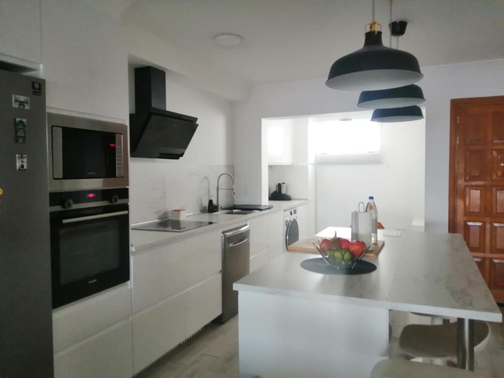 a white kitchen with a sink and a counter top at Morro Mar in Morro del Jable