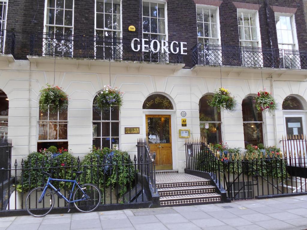 a bike parked in front of a building at George Hotel in London