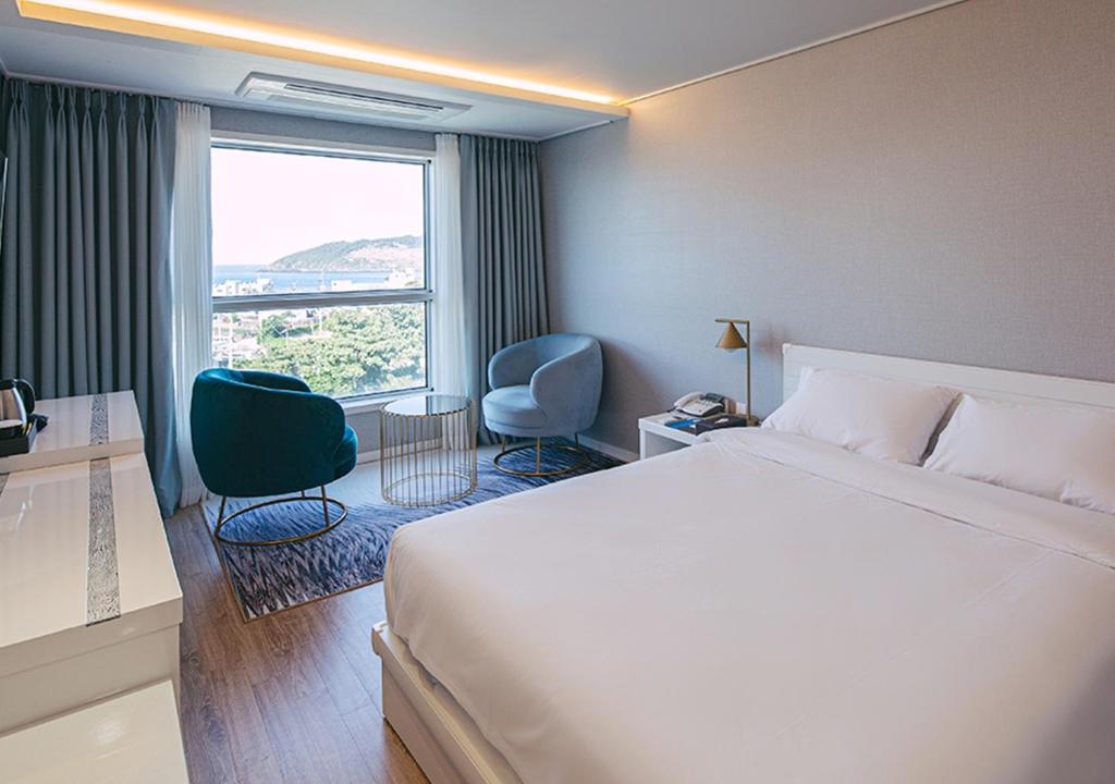Postel nebo postele na pokoji v ubytování Hotel Sweet Castle Jeju Hamdeok