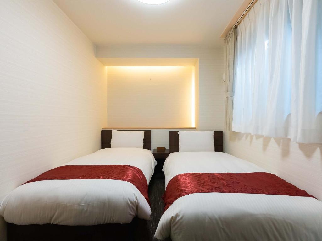 Postel nebo postele na pokoji v ubytování Kyoto inn Mio