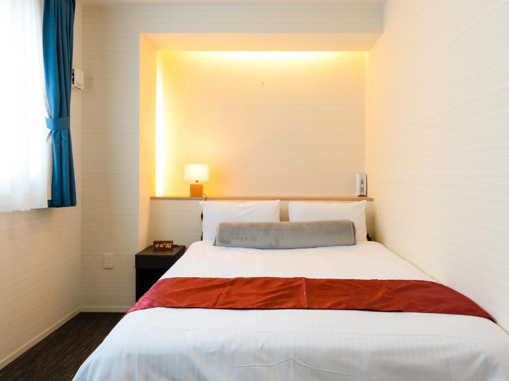 Postel nebo postele na pokoji v ubytování Kyoto inn Mio