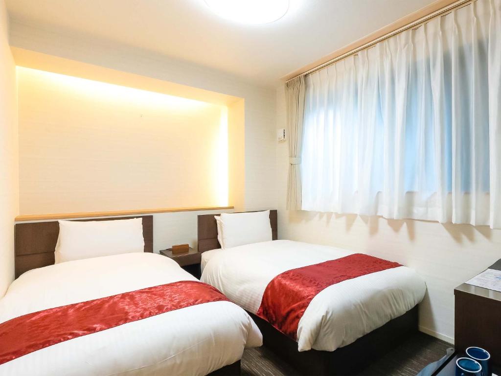 Postel nebo postele na pokoji v ubytování Kyoto inn Mio
