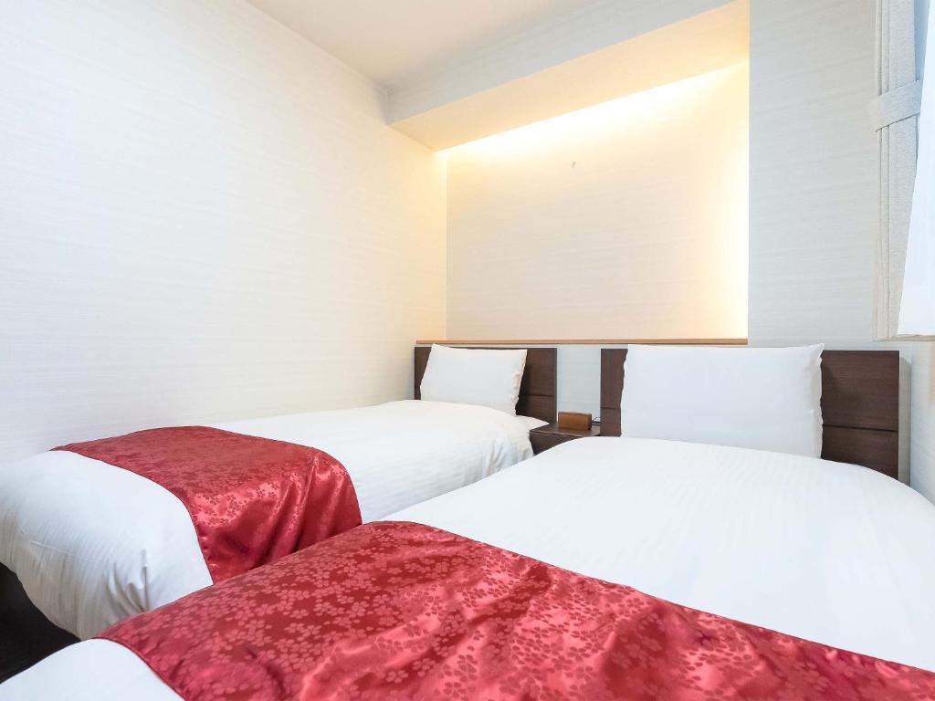 Postel nebo postele na pokoji v ubytování Kyoto inn Mio