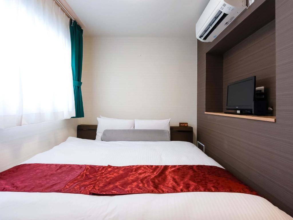 Postel nebo postele na pokoji v ubytování Kyoto inn Mio
