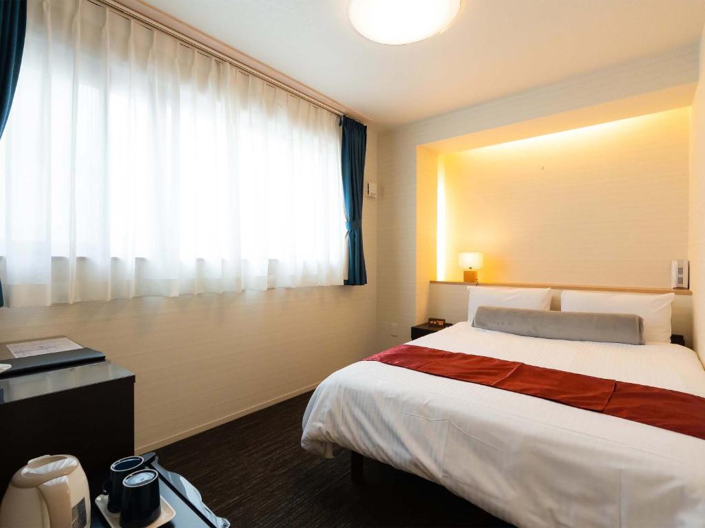 Postel nebo postele na pokoji v ubytování Kyoto inn Mio