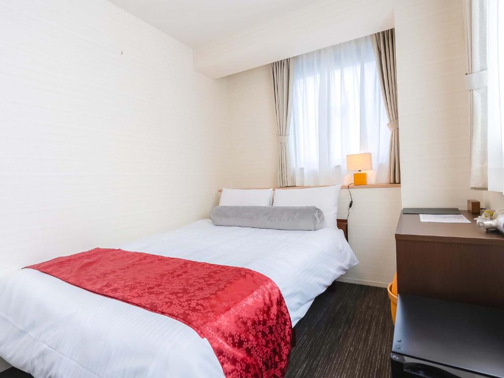 Postel nebo postele na pokoji v ubytování Kyoto inn Mio