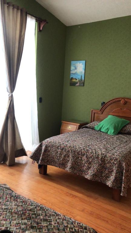 Postel nebo postele na pokoji v ubytování HOTEL PUEBLO GRANDE