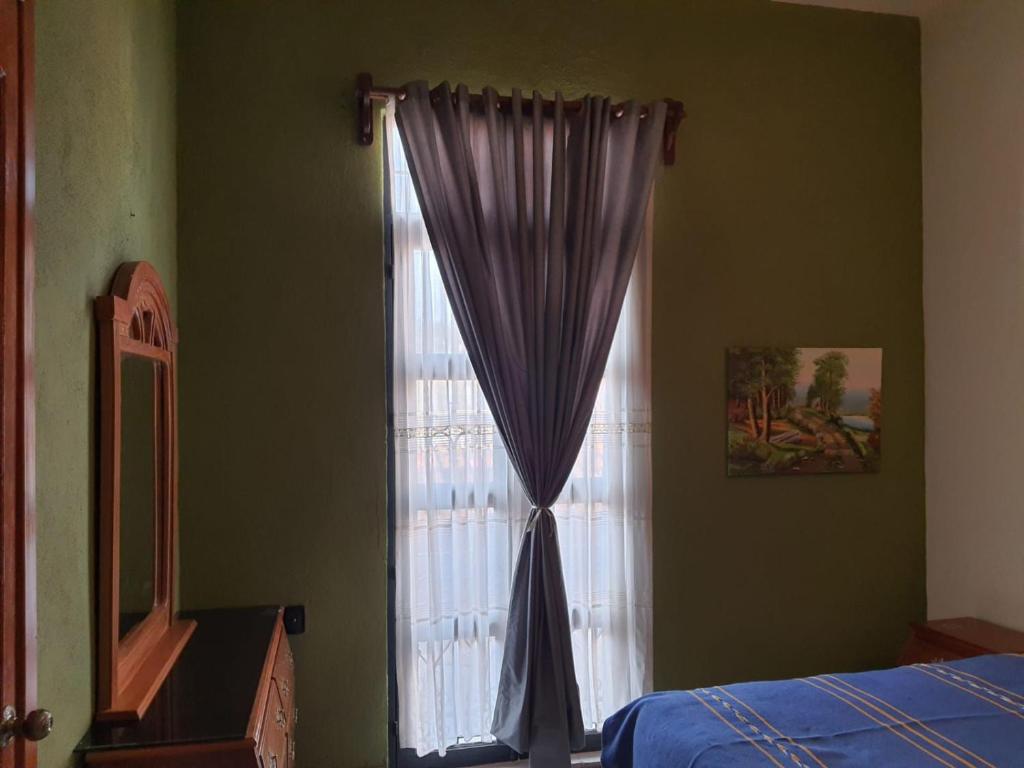 Postel nebo postele na pokoji v ubytování HOTEL PUEBLO GRANDE