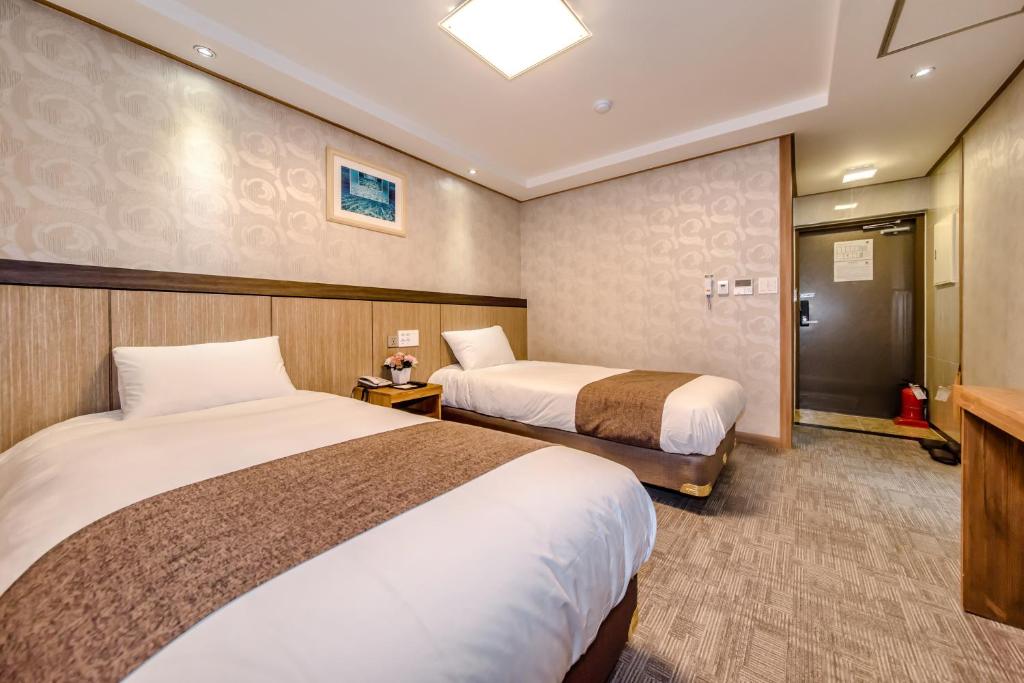 Postel nebo postele na pokoji v ubytování Index Hotel J Dream Jeju