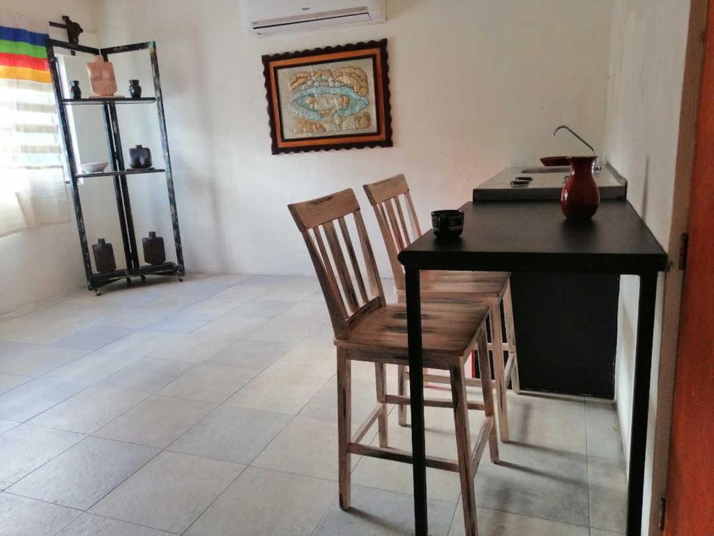 un escritorio con una silla y una mesa con un jarrón. en casa agave en San José del Cabo