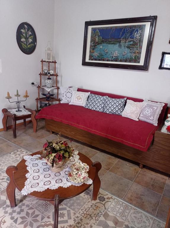 a bedroom with a bed and a table with flowers on it at TRADITIONAL HOUSE MARIA in Azoyirás